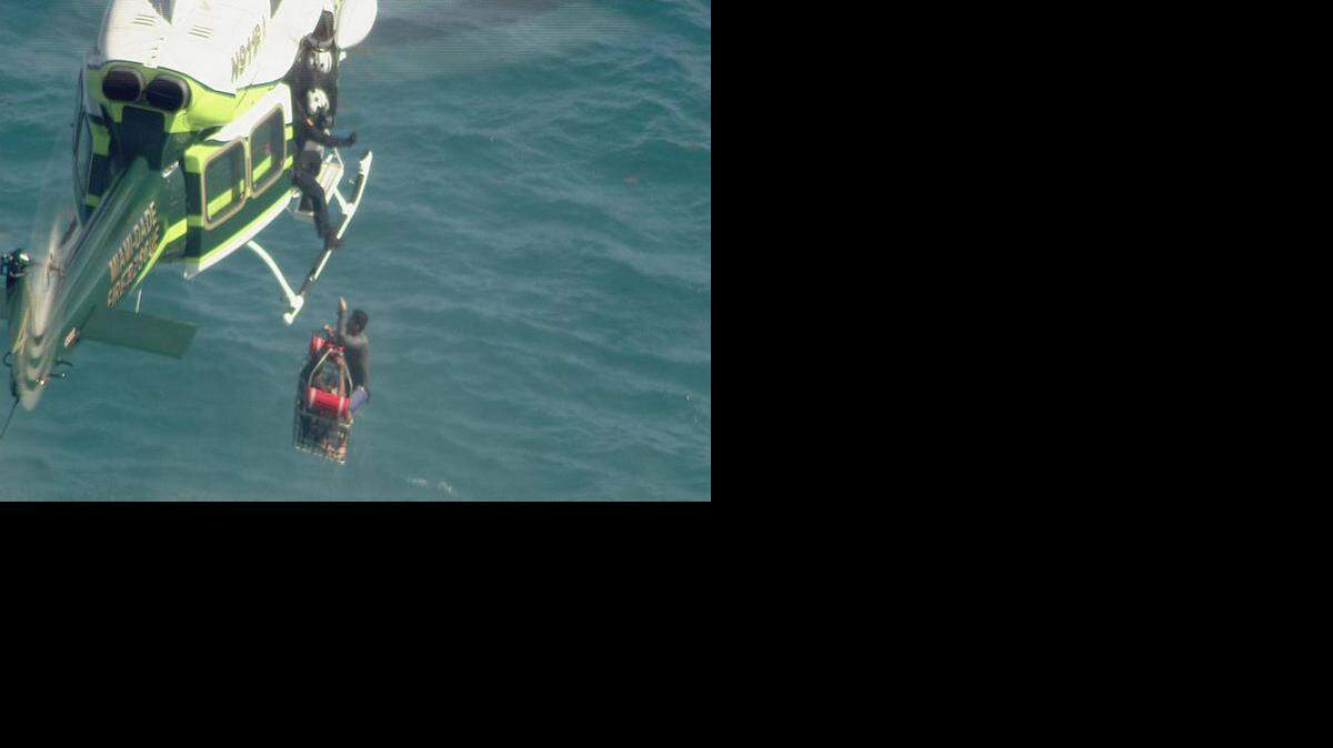 
A Miami Dade Fire Rescue helicopter pulls two men from the waters off Sands Key following reports that several Cuban migrants were spotted floating with little support.


