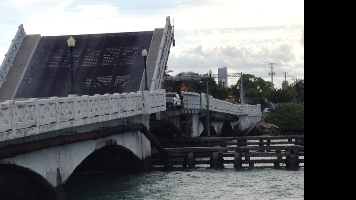 
Workmen examine the stuck Venetian Causeway east bridge at 5:30 pm Saturday, April 18, 2015.
