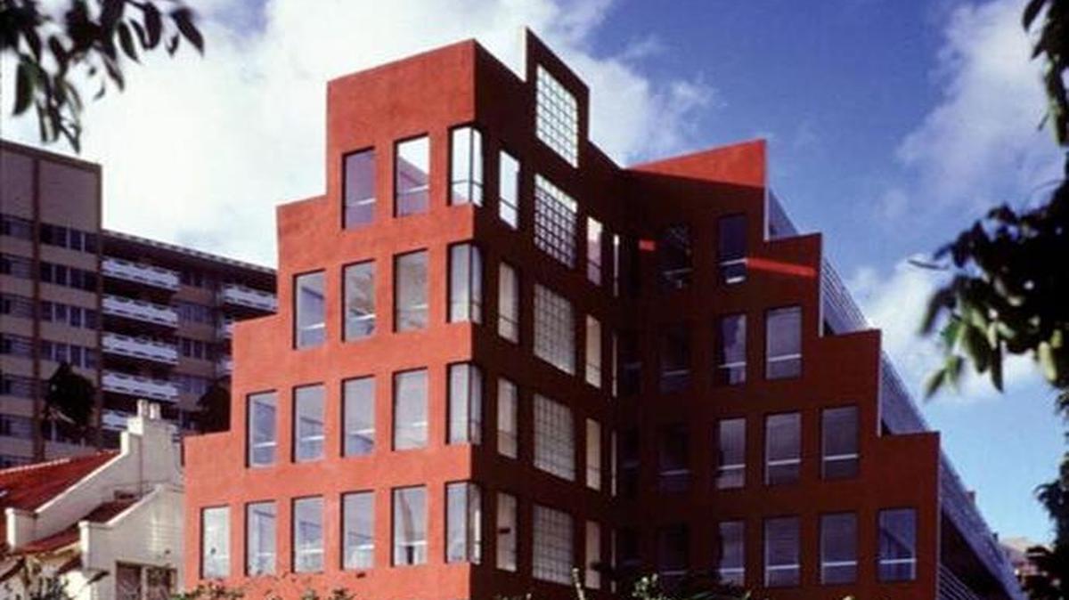 The red ziggurat facade of Arquitectonica’s Babylon Apartments in the building’s prime.