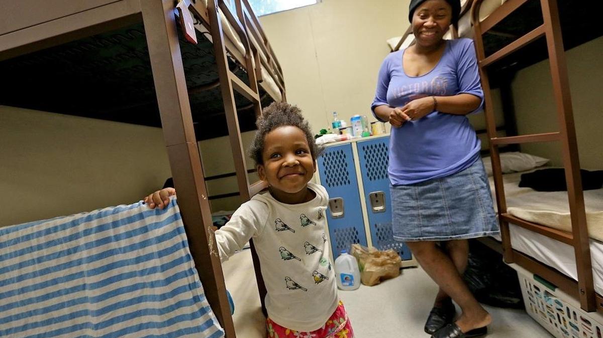 Zindaya Bell 4, and her mother Zulie Josil enjoy their new beds in their room at the Chapman Partnership on Thursday January 7, 2015.