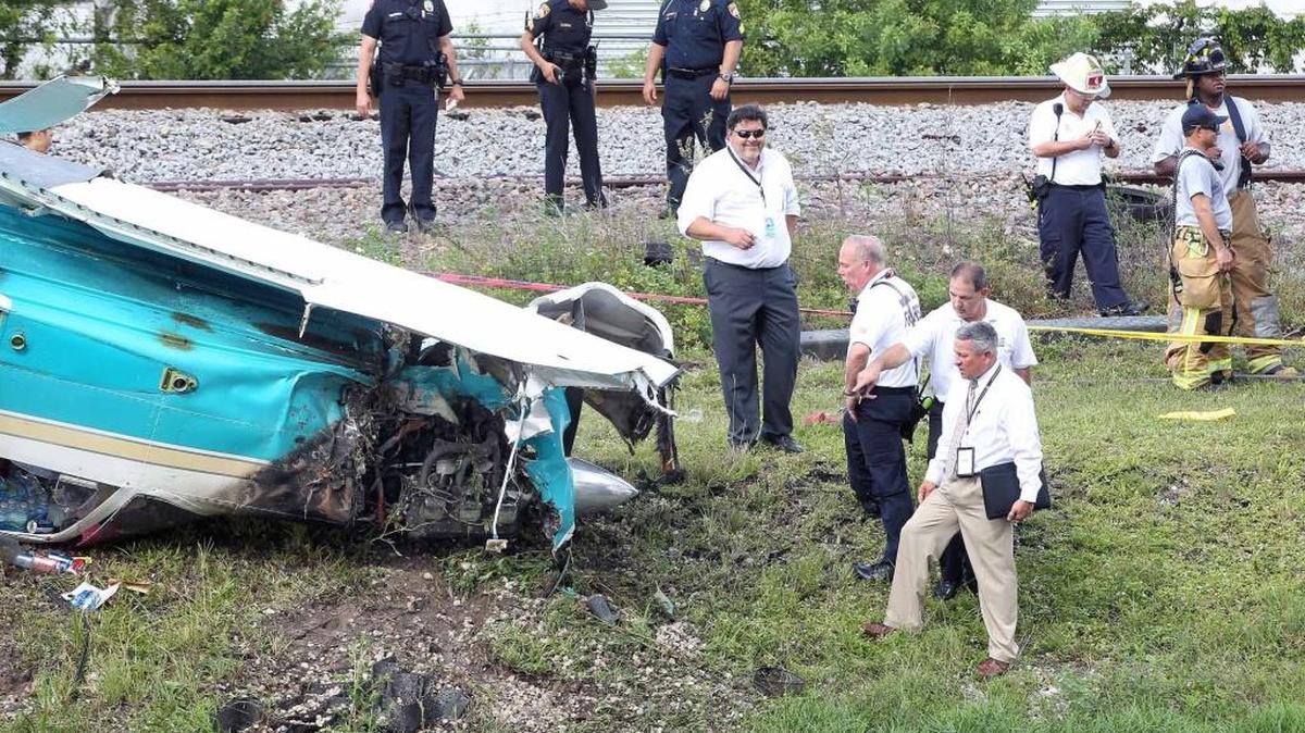 Miami Dade County Fire Rescue and FAA investigators inspect the aircraft that crashed shortly after takeoff east of Miami Opa-locka Executive Airport on Dec. 1.