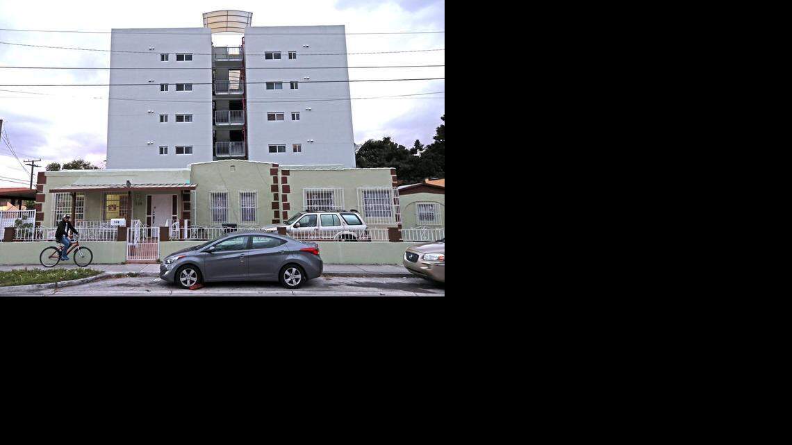 
An older historic home is shown in the shadows of a newer five-story apartment building in East Little Havana. Activists and preservationists are fighting an upzoning in the neighborhood.
