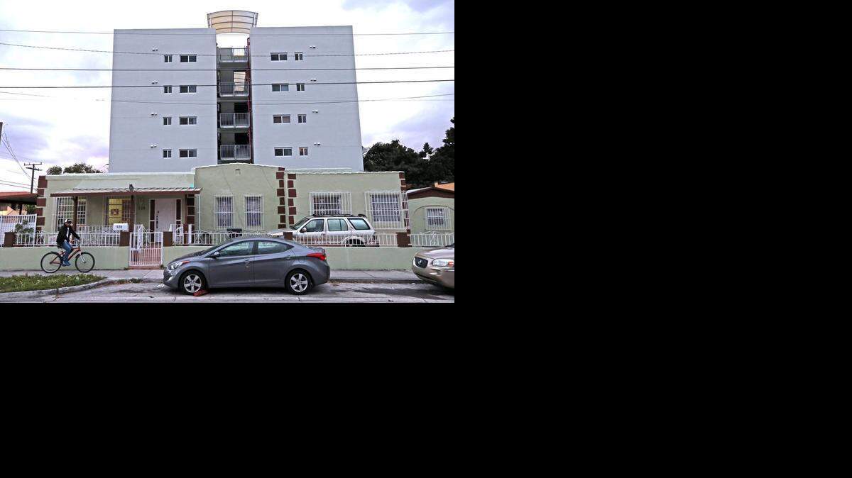 
An older historic home is shown in the shadows of a newer five-story apartment building in East Little Havana. Activists and preservationists are fighting an upzoning in the neighborhood.
