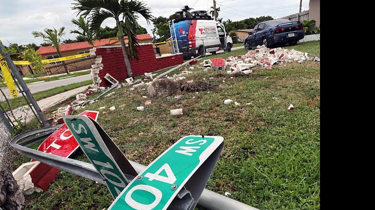 
A car rammed through a brick fence at a corner home in the 10400 block of Bird Road. The driver died and debris flew into the neighborhood.
