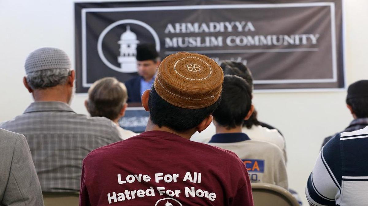 A young man listens as the Ahmadiyya Muslim Community of Miami holds a prayer vigil on Sunday, Dec. 13, 2015 for the victims of the San Bernardino shooting.