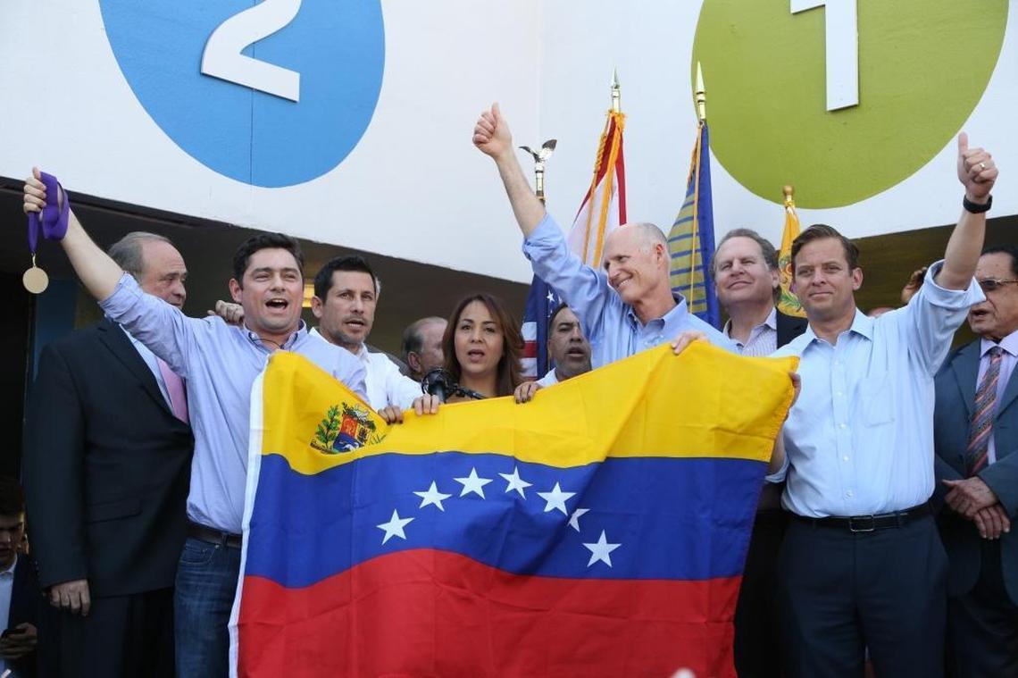 Florida Gov. Rick Scott, center, alongside Lt. Gov. Carlos Lopez-Cantera, right, shows support to Venezuelan people during the ‘Freedom Rally’ demanding the release of imprisoned activist Leopoldo Lopez in Doral on Monday, May 8, 2017.