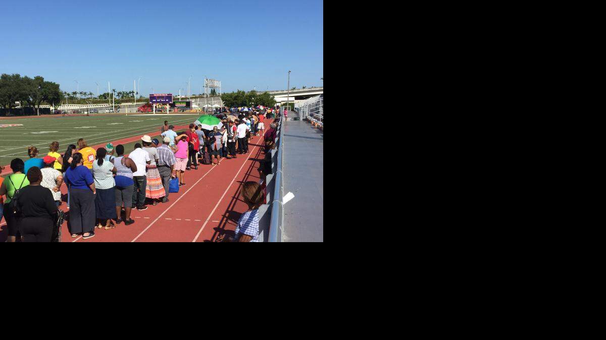 
Families wait in line at 10 a.m. on Nov. 7 to receive free food and toiletries from Farm Share at Miami’s Moore Park.
