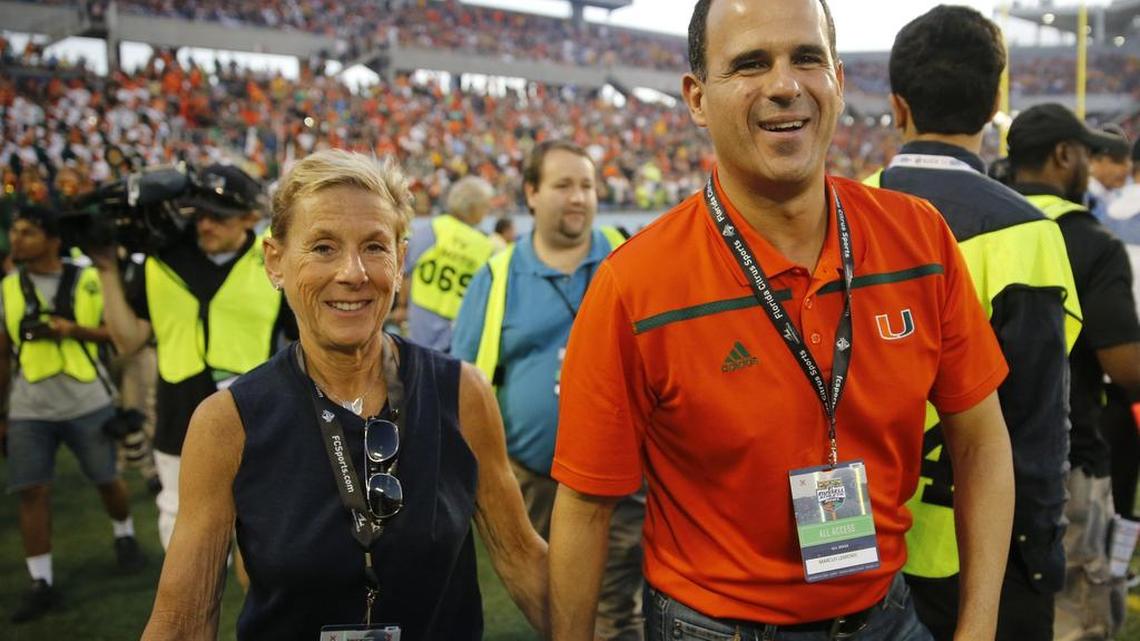 At right, Marcus Lemonis, star of The Profit, a CNBC reality show about saving small businesses, on the sidelines as the University of Miami takes on the West Virginia Mountaineers at the Russell Athletic Bowl in Orlando on Dec. 28, 2016.