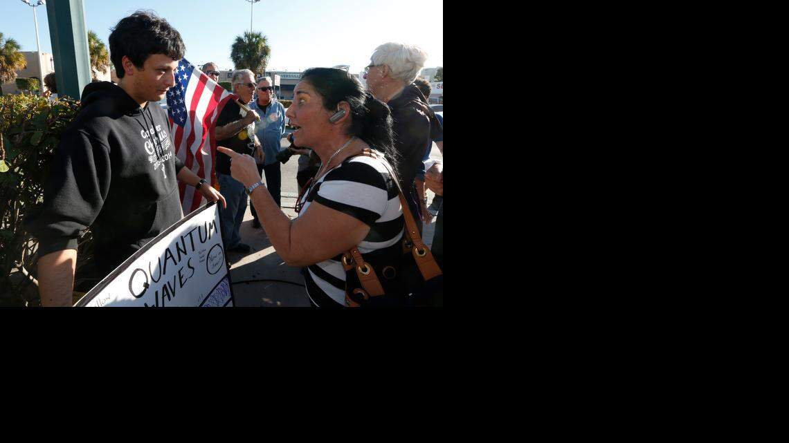 
An unidentified woman argues with Bryan Medina regarding Medina's congratulatory sign at Versailles Restaurant in Miami on Wednesday, Dec. 17, 2014 after President Obama's decision to normalize relations between Cuba and the United States

