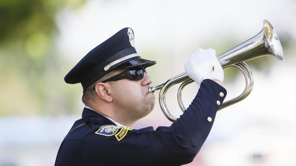 Officer Sergio Diaz plays the military bugle on Memorial Day to commemorate the fallen men and women who had served in the U.S. armed forces, at Triangle Park in Hialeah on Monday, May 29, 2017. This year’s Memorial Day ceremony will begin at 10 a.m. Monday at Triangle Park.