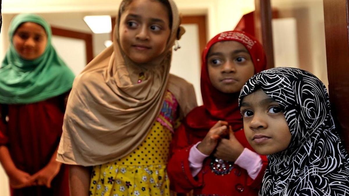 Rania Ishoof, 9, left, Maryum Rasikh, 6, Hafsa Sulieman, 7, and Sauda Sulaiman, 4, listen to remarks about the Orlando killings prior to a fast-breaking dinner during Ramadan at the Islamic School of Miami on June 13, 2016.