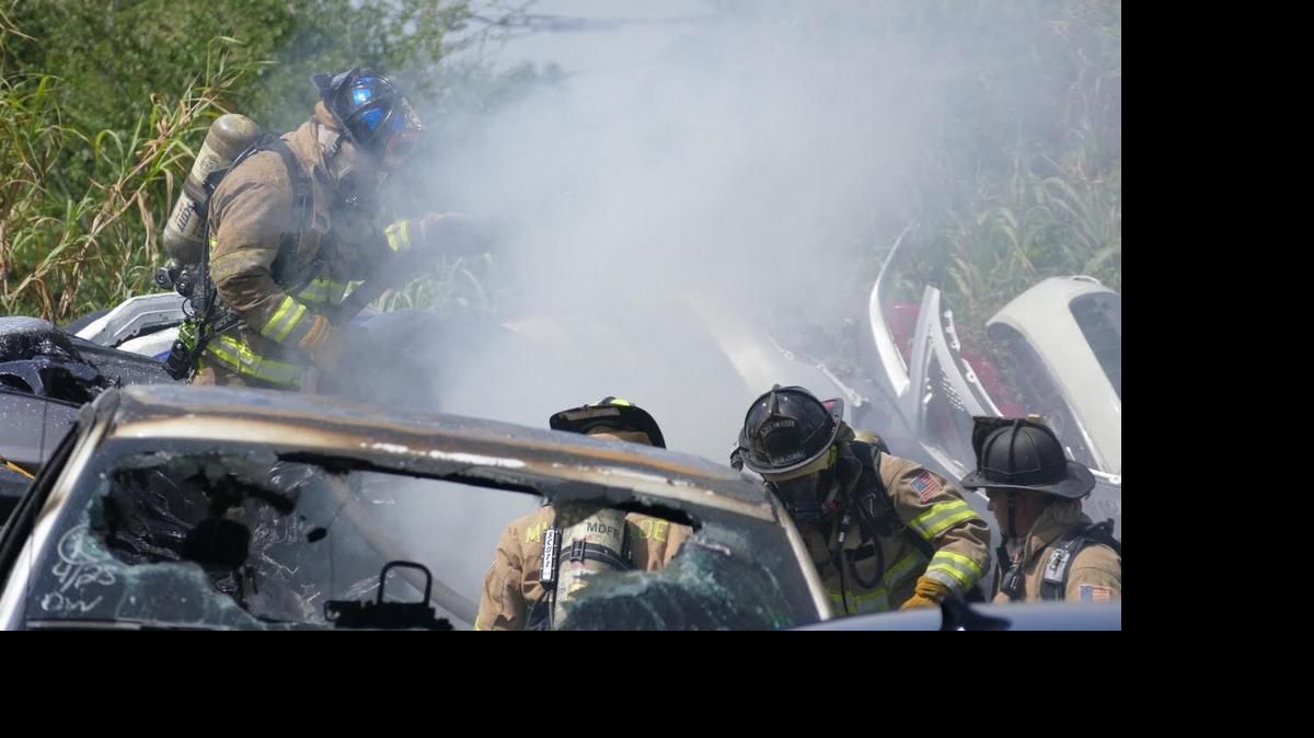 
Miami-Dade firefighters work a junkyard fire on Wednesday morning.
