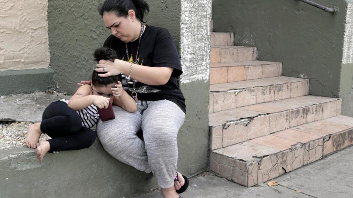 Taymara Linarte fixes her three-year-old daughter’s hair in front of the Little Havana building where she and her four children live. Residents of the building at 946 SW 4th St. face eviction due to a city of Miami lawsuit demanding everyone move out because of deplorable living conditions. Linarte does not want to leave because she can’t afford to go anywhere else in Miami.