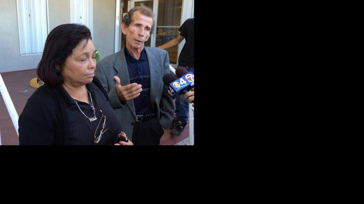 
Pastor Mercedes Meneses and her husband, Romelio Meneses, speak Tuesday, Oct. 28, 2014, at a memorial at Kinloch Park, where their son -- in an attempt to retrieve a basketball -- was electrocuted Oct. 27 after jumping a fence to an FPL substation.
