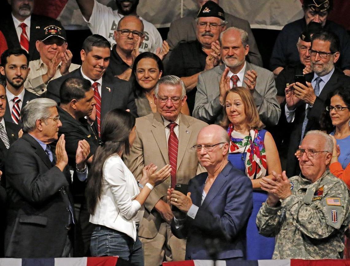 Family members of the Brothers to the Rescue victims whose plane was shot down over international waters are acknowledged by President Donald Trump at the Manuel Artime Theater in Miami on Friday, June 16, 2017.