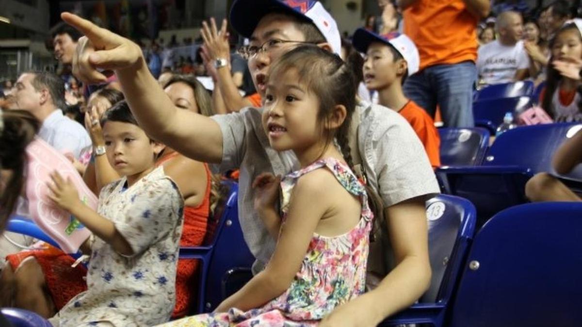 Jun Sasaki shares a moment with his daughter Mana Sasaki at the Miami Marlins baseball game Sunday at Marlins Park. The Marlins celebrated Japanese Heritage Day, where more than 400 Japanese fans attended.