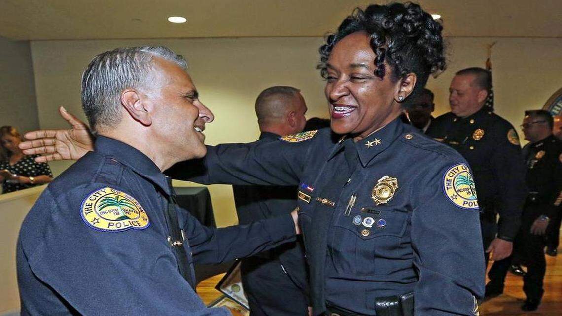 
Assistant Miami Police Chief Anita M. Najiy contragulates Jorge R. Colina during a promotion ceremony last week.
