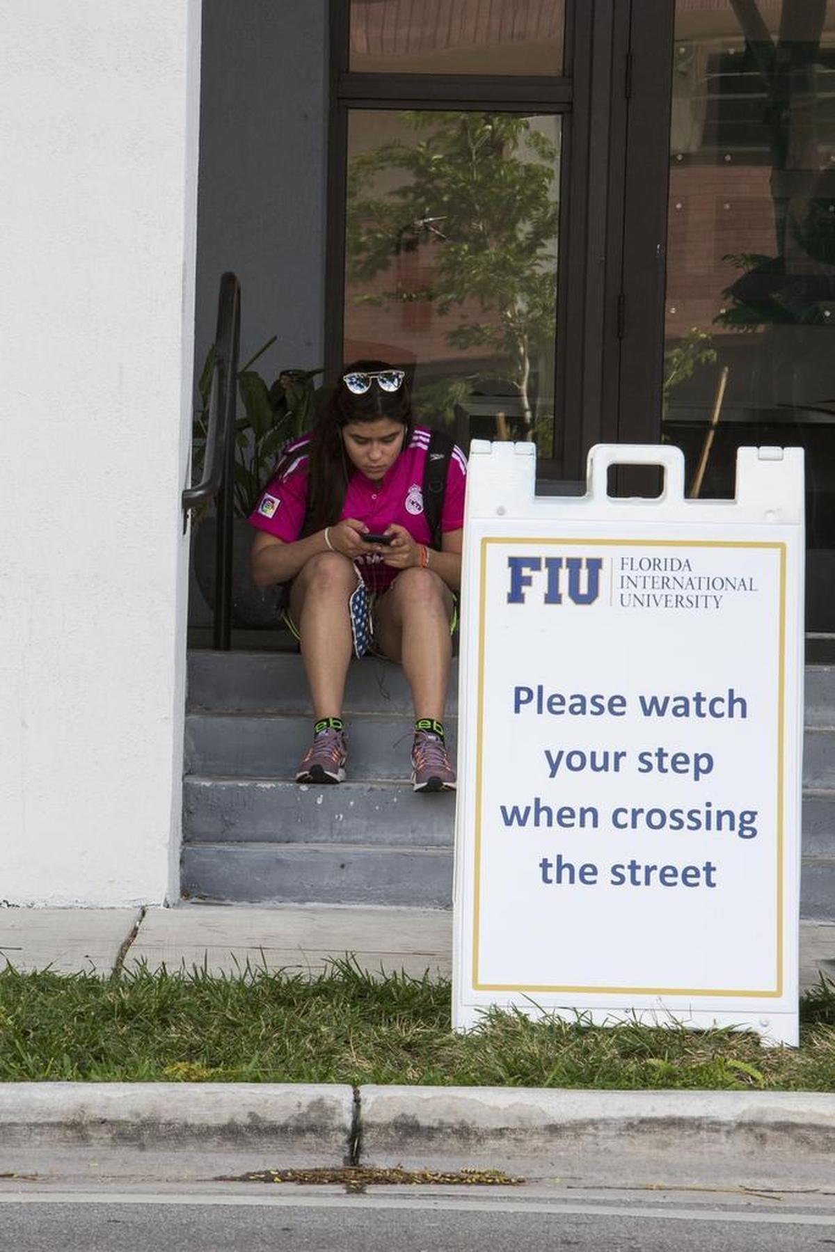 FIU junior Nathalie Sanchez awaits a shuttle in Sweetwater to take her to Florida International University’s main campus on Southwest Eighth Street on Monday, March 19, 2018. Southwest Eighth Street between 107th and 117th avenues is closed due to the FIU bridge collapse last Thursday, March 15, 2018.