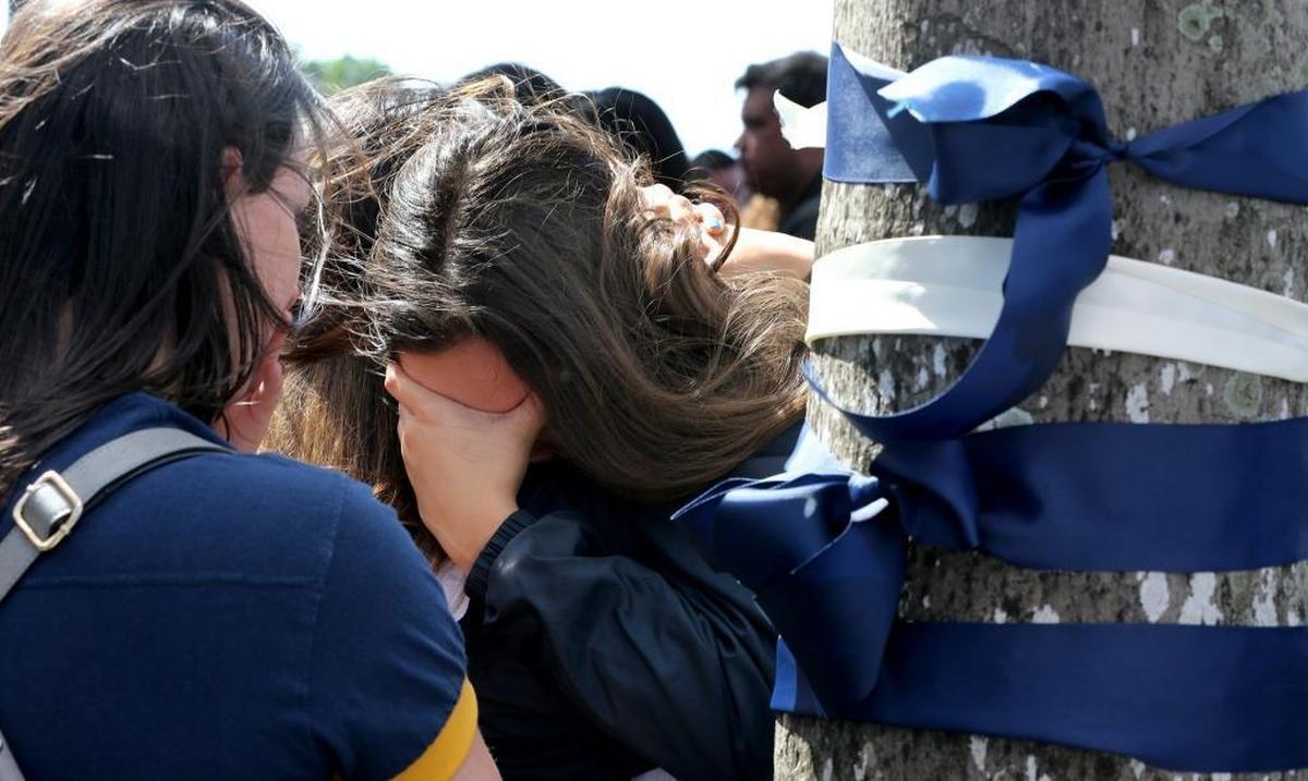 Students mourn during a vigil on Wednesday, March 21, to remember the six people killed at the FIU bridge collapse last Thursday.