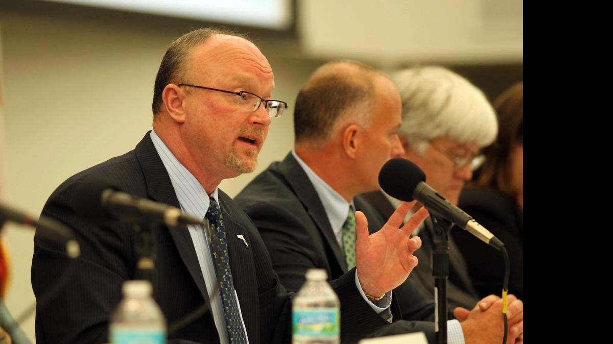 
Kevin McCarty, (center talking) commissioner of the Florida Office of Insurance Regulation, talking at a public hearing at the Miami Dade College Wolfson Campus in 2012. This year, the office will again begin regulating rate increases for Affordable Care Act plans after a two-year ban. 
