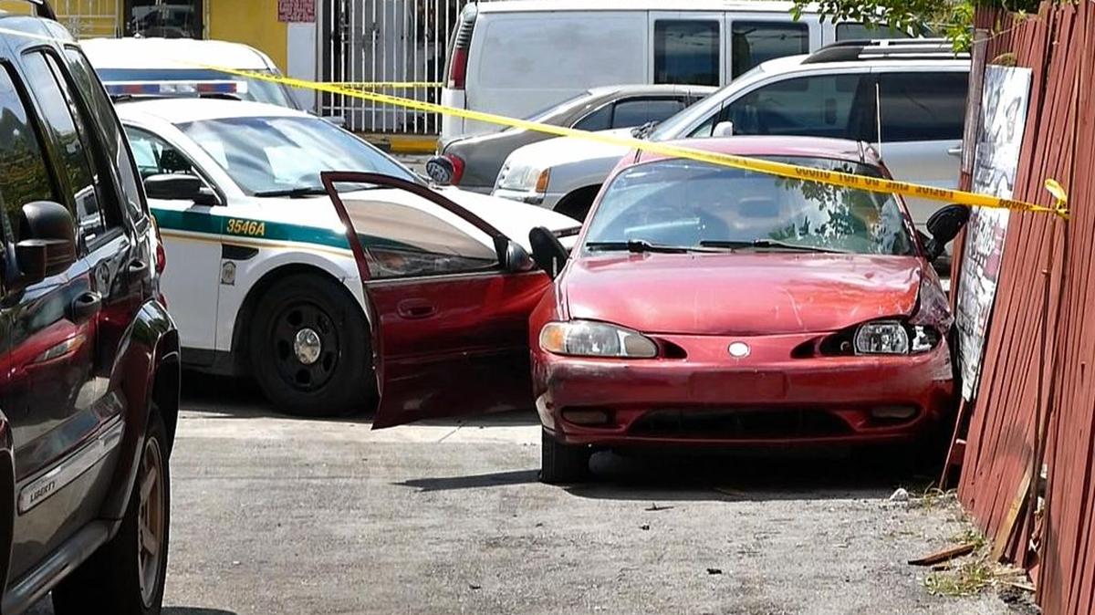 The red get-a-way car that got stuck in a dead end alley then backed up into police cruisers after wild chase throughout Miami on Friday, April 1, 2016.