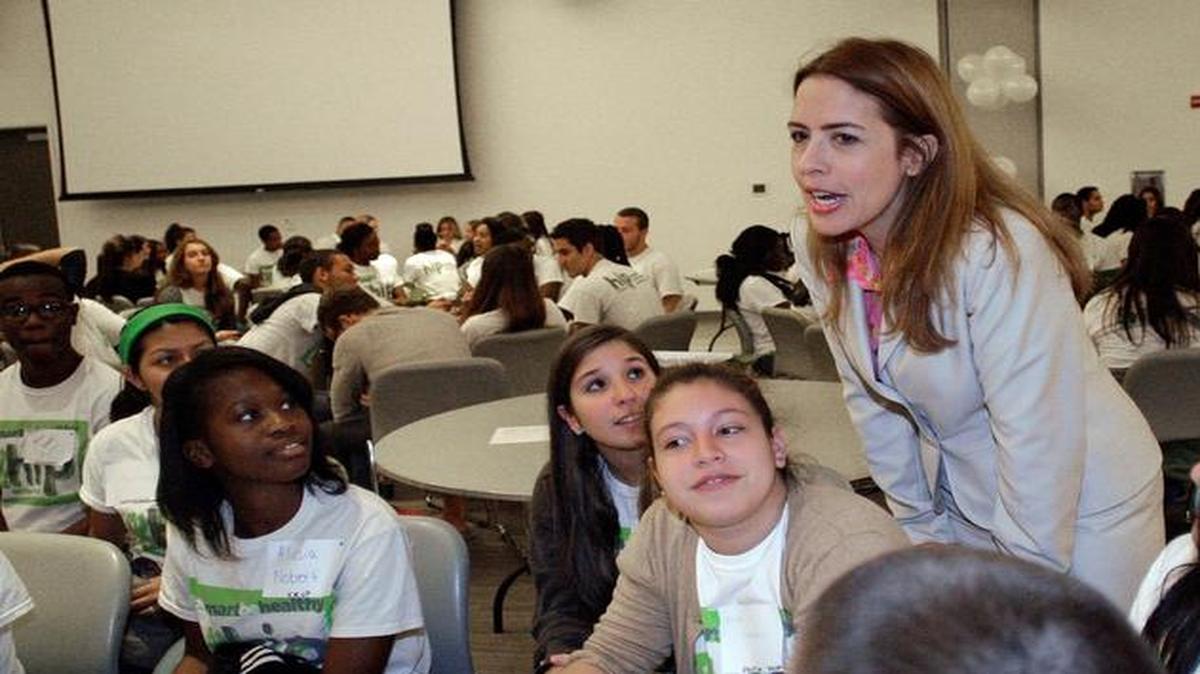 
Raquel Regalado, a school board member, speaks with students in this March 2014 file photo. 
