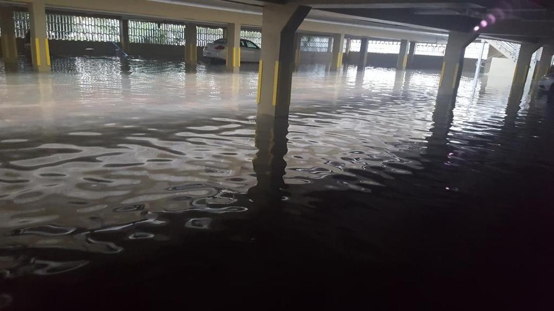 Water pools in a parking garage at 1441 Lincoln Rd. Wednesday evening during high tide.