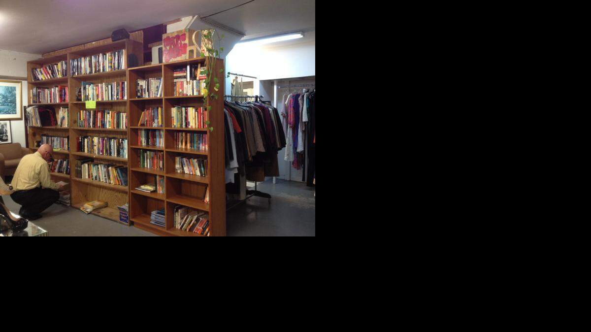 
Jose Lebron, a regular customer at SoBe Thrifty in South Beach, looks through books at the store Dec. 2. After more than 25 years, the store will be closing at the end of January.
