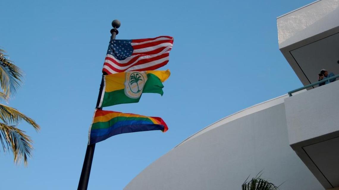 The American flag, the City of Miami Beach flag and the rainbow flag fly at Miami Beach City Hall during Gay Pride Week.