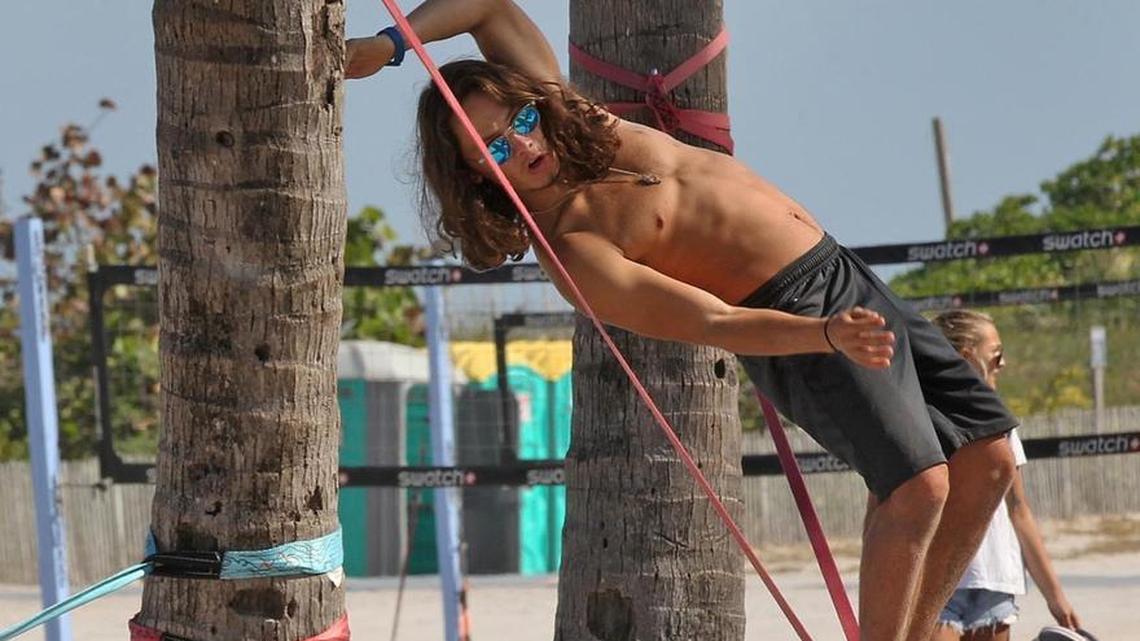 Miami Beach is swinging with activity as Rodolfo Rojas keeps his balance on a slack line on Ocean Drive and 8th street as spring breakers and locals take over South Beach on Tuesday, March 20, 2018.