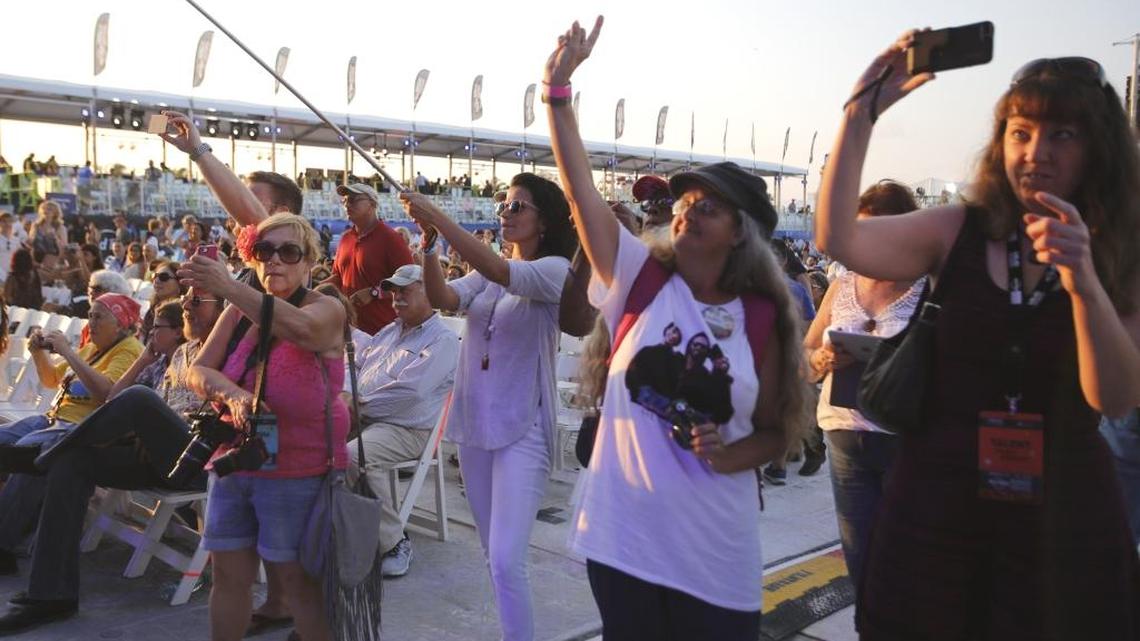 Concert fans pull out their cameras during performances at a concert held to mark Miami Beach’s centennial in March 2015. A three-day music festival is proposed for the weekend after Art Basel on the same stretch of South Beach this upcoming December.