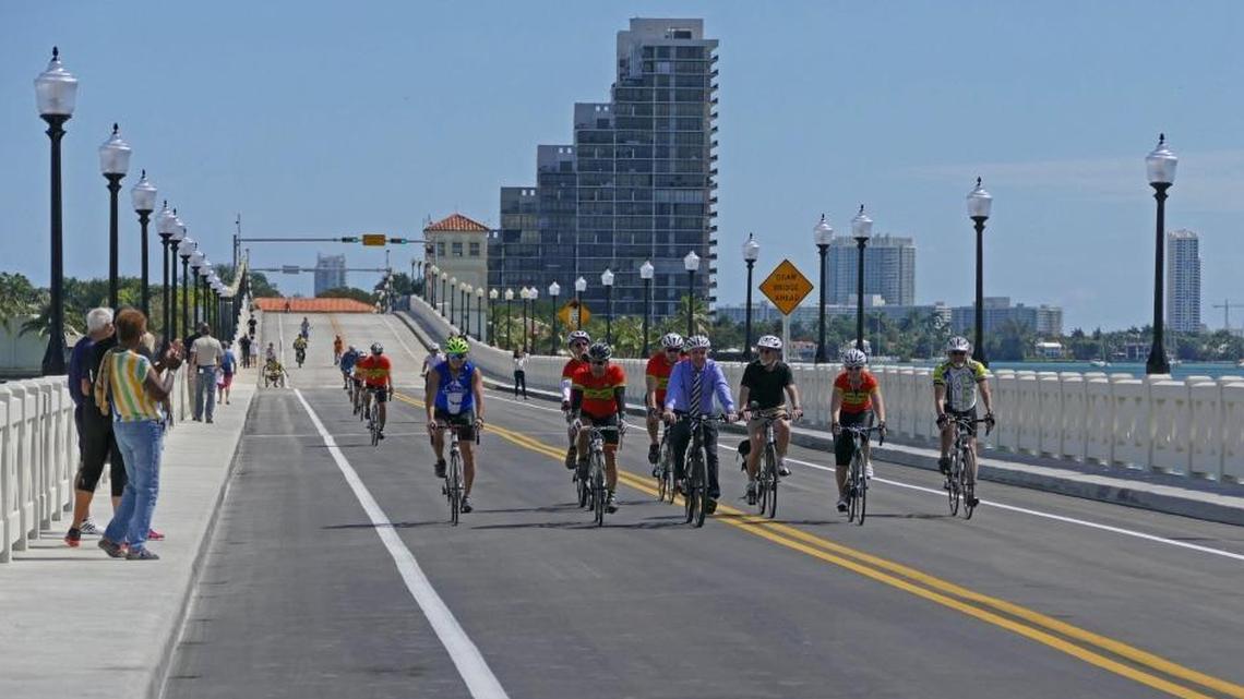 Cyclists including Miami-Dade Mayor Carlos Gimenez, center, ride on the Venetian Causeway bridge just before it reopens to car traffic after nine months of construction Monday, Feb. 29, 2016.