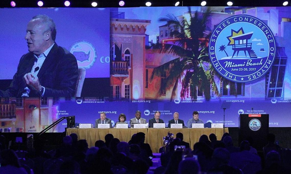 On the large screen, the mayor of Sacramento, Darrell Sternberg participates in conversation regrading digital technology for cities at 85th Annual U.S. Conference of Mayors inside the Sparkle Ballroom on Miami Beach's Fontainebleau hotel on Sunday, June 25, 2017.