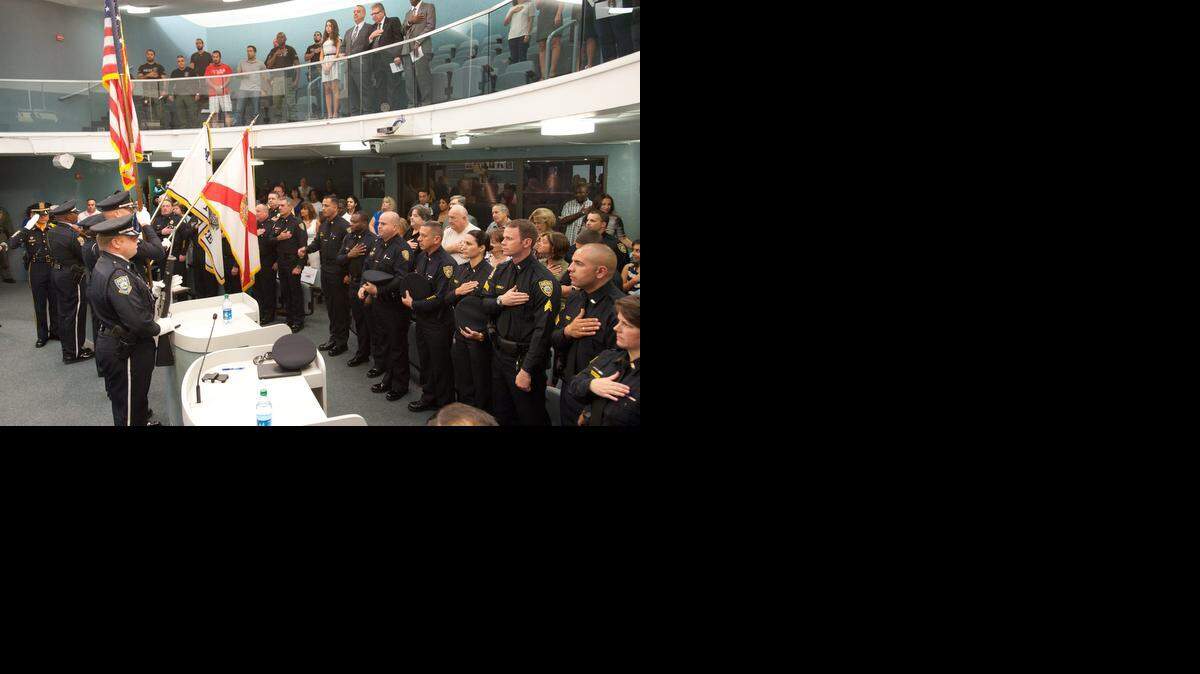 
The Miami Beach Police Honor Guard present colors during a police promotion ceremony at Miami Beach City Hall, Friday, Oct. 10, 2014, in Miami Beach. The promotions included two majors, two captains, three lieutenants, and three sergeants. More than 100 people attended the ceremony, which was followed by a receptions with snacks and refreshments.
