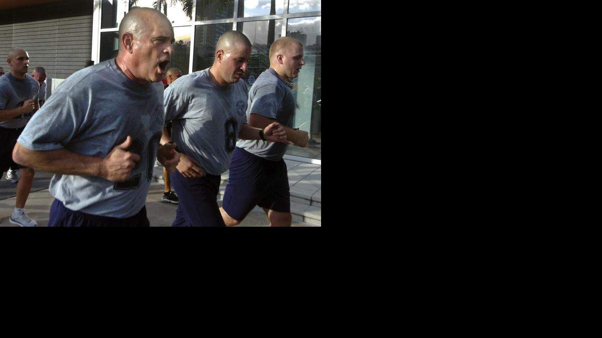 
Miami Beach City Commissioner Ed Tobin (No. 20), runs a 2.5-mile course with other Miami police cadets half his age in 2011. Tobin, a 52-year-old lawyer, graduated the academy and now wants to quit the City Commission to become a Miami Beach cop.
