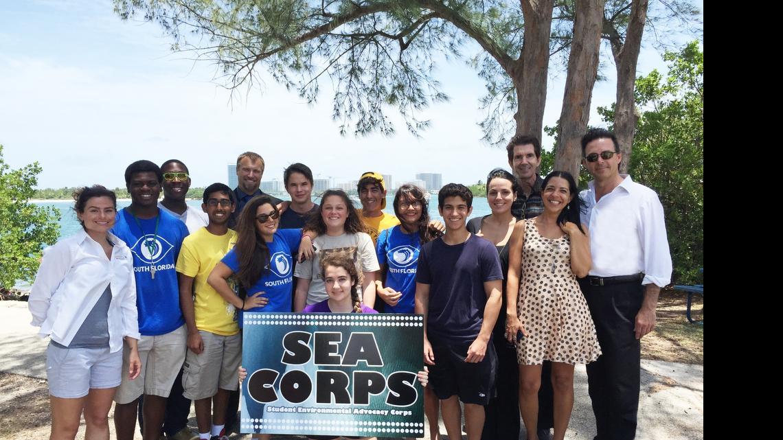 
SEA Corps, from left: MAST Science teacher Bridgette Gunn; MAST student Clifton Lawrence; FIU grad student William Stirrup; MAST student Saad Masud; Dr. Michael Heithaus, dean of FIU College of Arts and Sciences; MAST students Juliana Kaboudi, Noe Ley, Jessi Dorney, Adres Martinez, Lourdes Pajuelo, Roberto Pantoja; Ady Arguelles, COO of Celebration of the Sea Foundation; MAST Principal Dr. Matthew Welker; Denise Fernandez, program director for Celebration of the Seas Foundation; Patxi Pastor, founder and CEO of Celebration of the Sea Foundation; and MAST student Deanna Baumann (holding sign).

