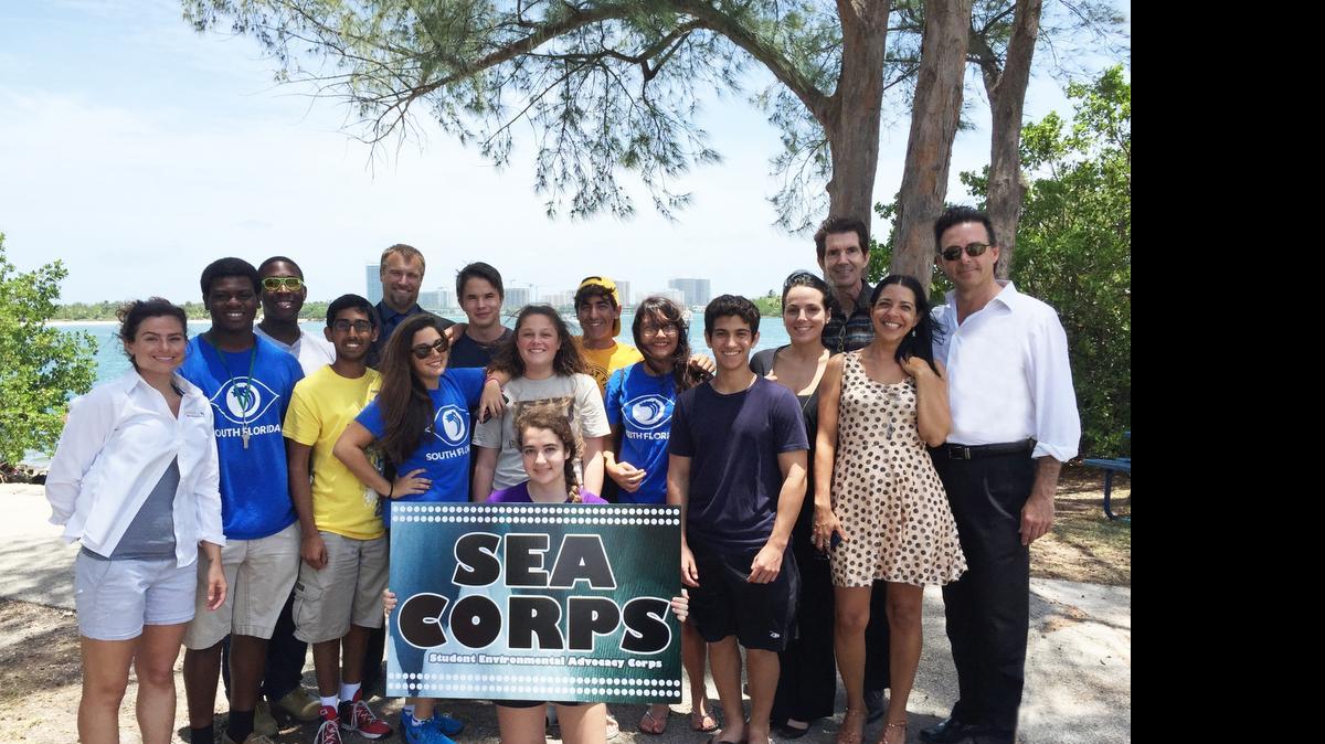 
SEA Corps, from left: MAST Science teacher Bridgette Gunn; MAST student Clifton Lawrence; FIU grad student William Stirrup; MAST student Saad Masud; Dr. Michael Heithaus, dean of FIU College of Arts and Sciences; MAST students Juliana Kaboudi, Noe Ley, Jessi Dorney, Adres Martinez, Lourdes Pajuelo, Roberto Pantoja; Ady Arguelles, COO of Celebration of the Sea Foundation; MAST Principal Dr. Matthew Welker; Denise Fernandez, program director for Celebration of the Seas Foundation; Patxi Pastor, founder and CEO of Celebration of the Sea Foundation; and MAST student Deanna Baumann (holding sign).
