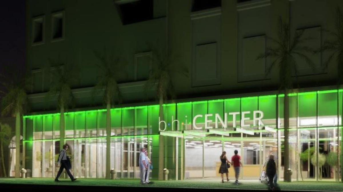 This rendering shows the outside of the new community center at night.