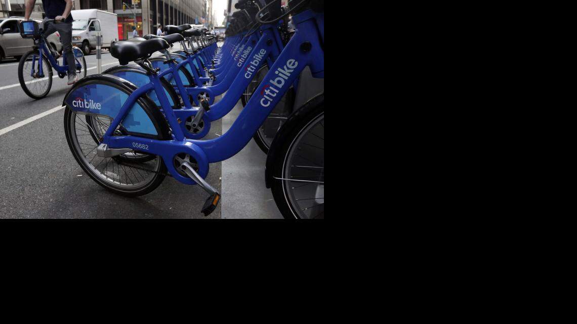 URBAN WHEELS:  Citi Bikes line a street in Midtown Manhattan in New York City during the summer.