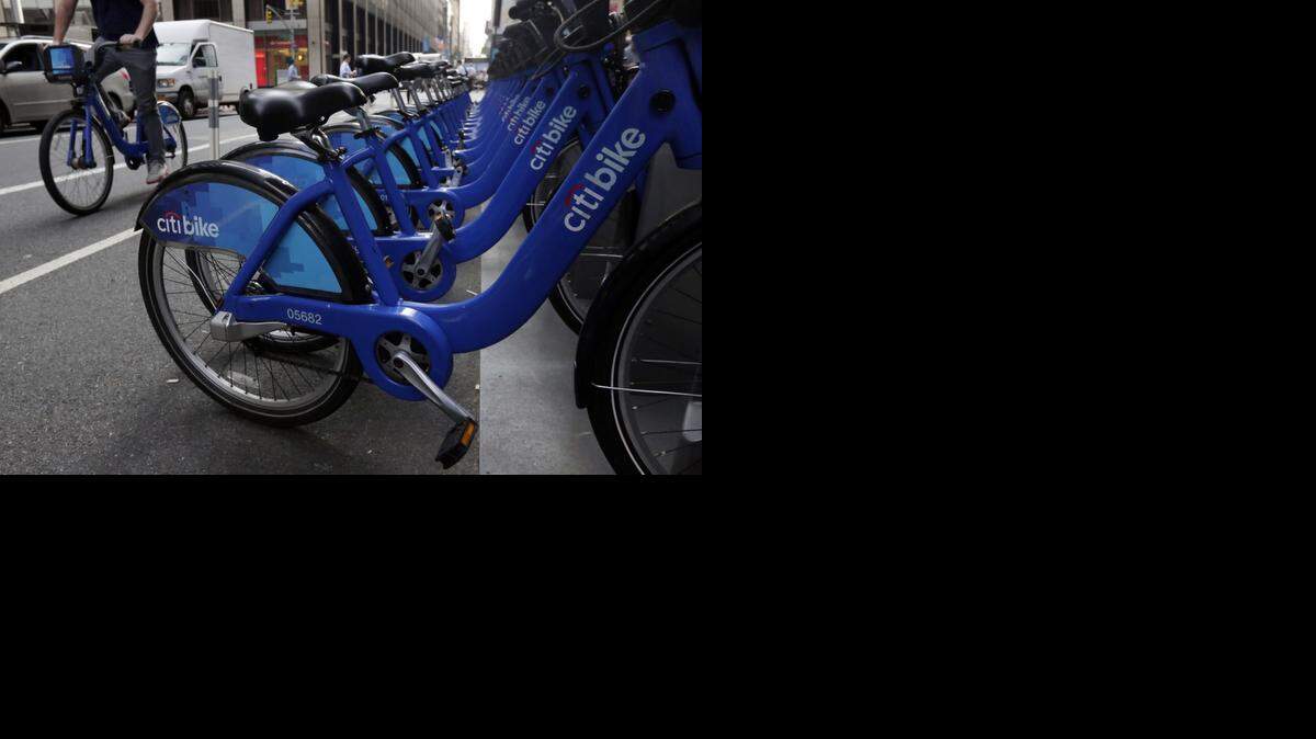 URBAN WHEELS:  Citi Bikes line a street in Midtown Manhattan in New York City during the summer.