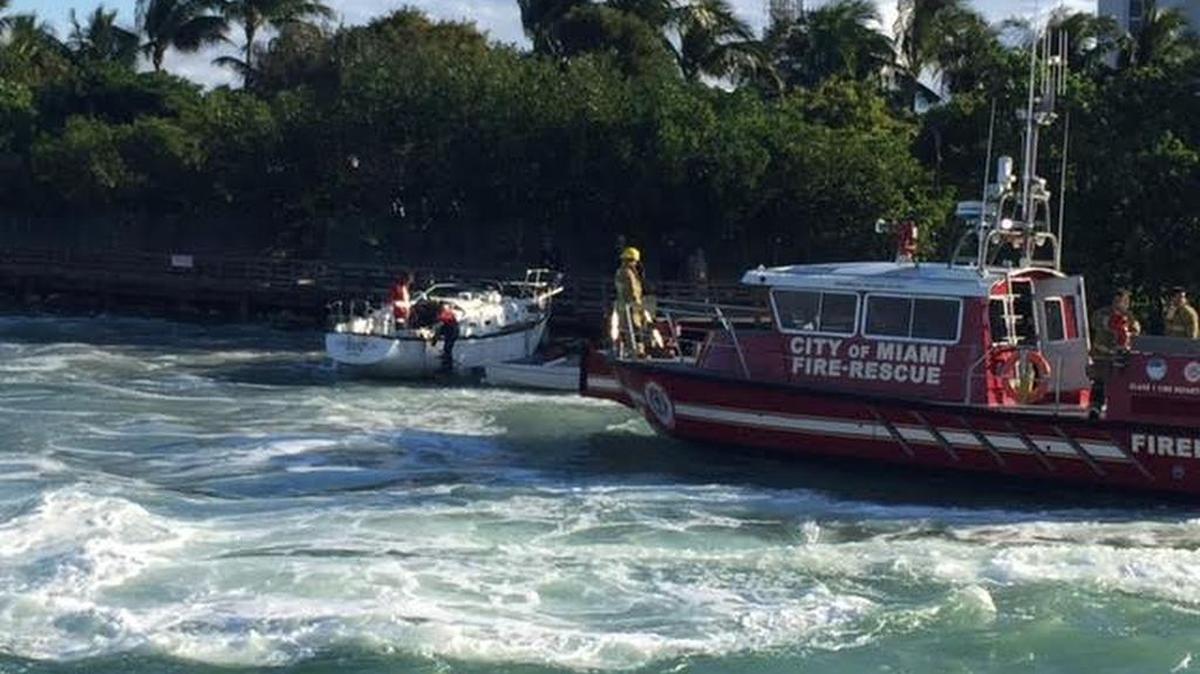 A Miami fire crew investigates a boat crash Sunday near Maurice Gibb Park. a mast struck a power line.