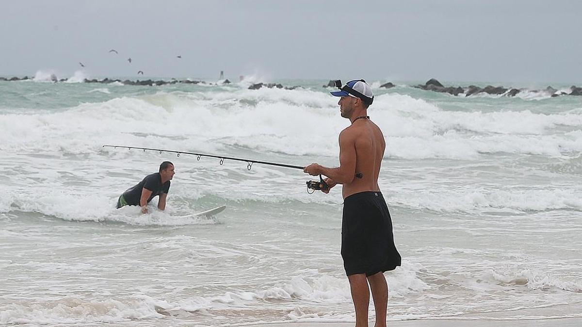 Bobbie Backlash, fishes on the beach at South Pointe, Miami Beach, as Hurricane Matthew moves closer to Florida,Oct. 6, 2016.
