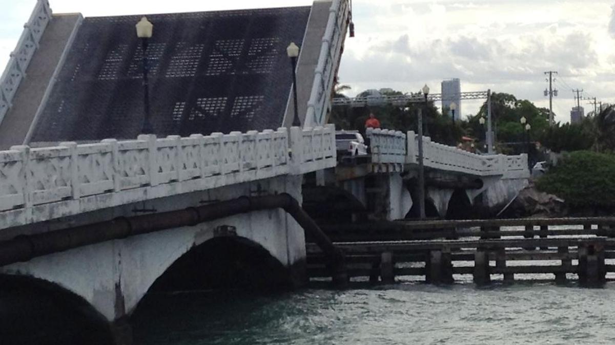 Workmen examine the stuck Venetian Causeway east bridge in April 2015.