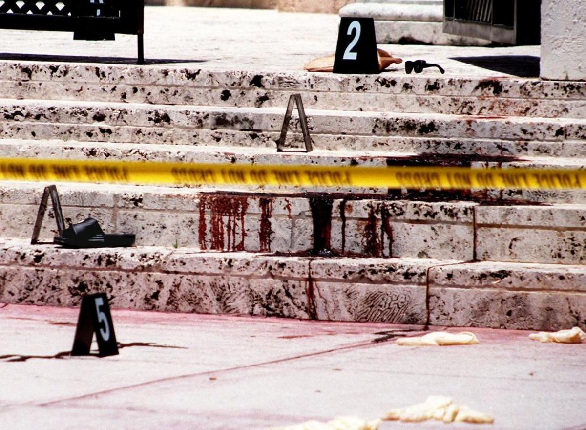 Blood, a shoe, and sunglasses on the steps of Gianni Versace’s South Beach mansion.