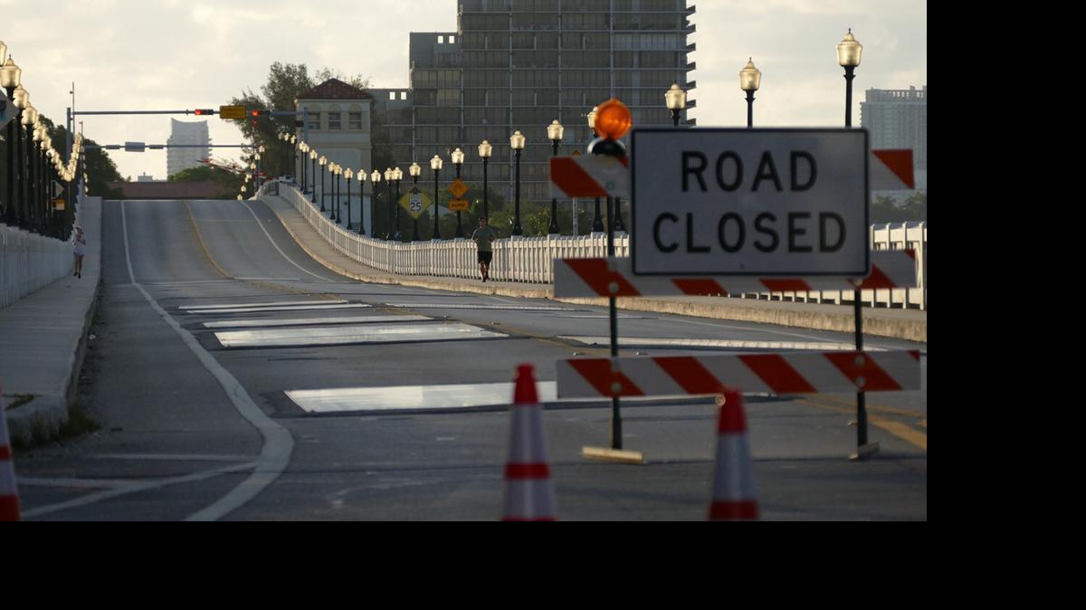 
A jogger runs westbound over the Venetian Causeway bridge on the first day of a nine-month closure for repairs. 
