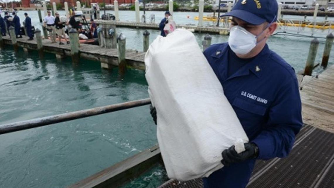 
Members of the Coast Guard offload approximately 1,100 kilograms of cocaine and 4,420 pounds of marijuana that were seized at sea at the Coast Guard Base Miami Beach, Sept. 29, 2015.
