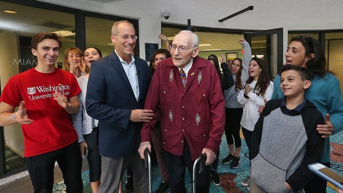 Former state Sen. Dan Gelber, left center, alongside his father and former Miami Beach Mayor Seymour Gelber, is cheered on by family and friends at Miami Beach City Hall on Tuesday, Jan. 31, 2017, after he filed paperwork to run for mayor of the city.