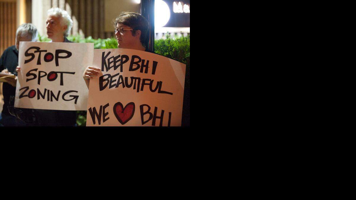 
Bay Harbor Islands residents Vincent Martino and Catherine Davalle express their opposition to proposed zoning changes outside Town Hall on Monday, Nov. 10, 2014.
