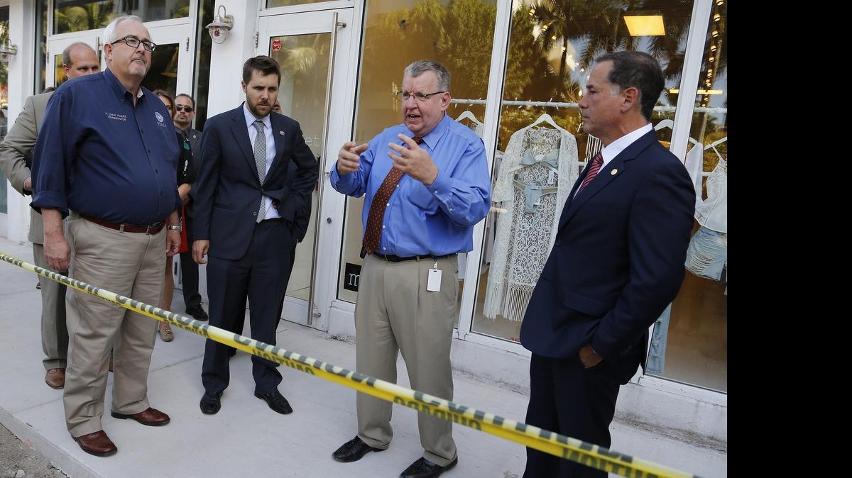 
W. Craig Fugate, left, Brian Deese, and Mayor Philip Levine, right, listen as city engineer Bruce A. Mowry explains the drainage project on Sunset Harbour on Wednesday. The federal officials met with Miami Beach officials a day before President Barack Obama's visit Thursday to the National Hurricane Center.


