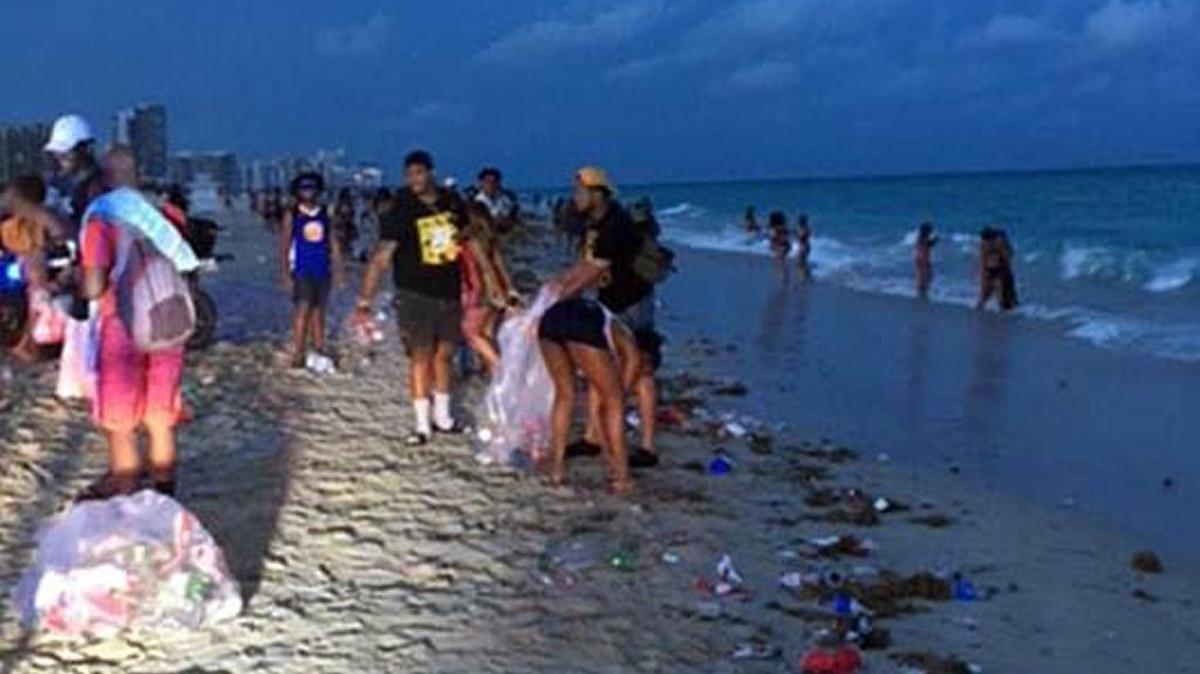Spring Break beachgoers, led by members of Florida International University’s Alpha Phi Alpha Fraternity, helped pick up litter the night of March 13.